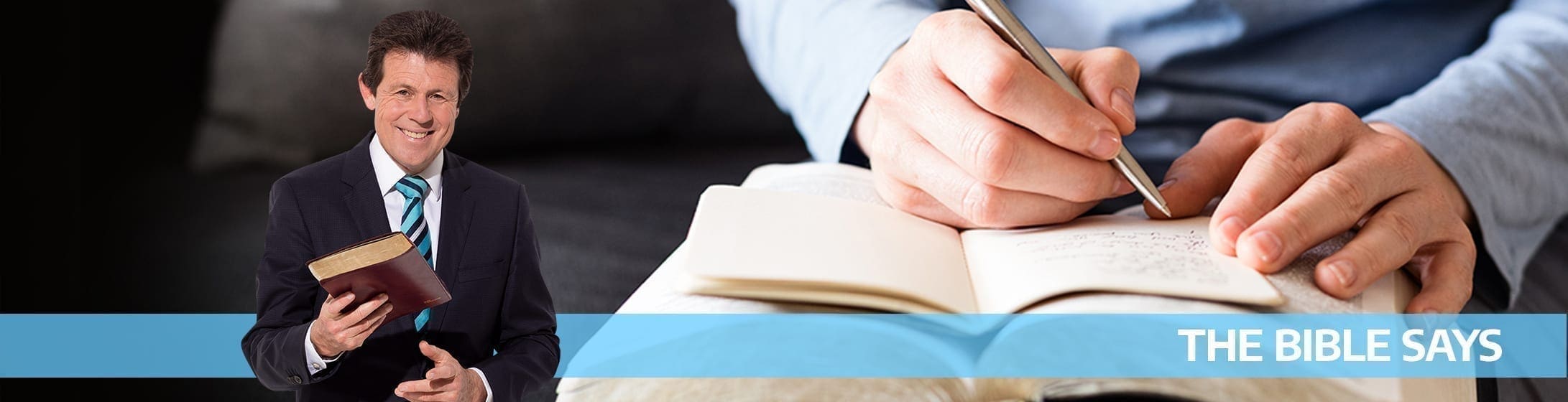 A man on a suit holding a book